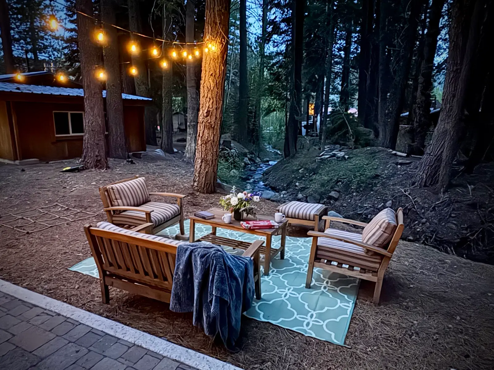 Creekside seating under string lights at Donner Lake Inn