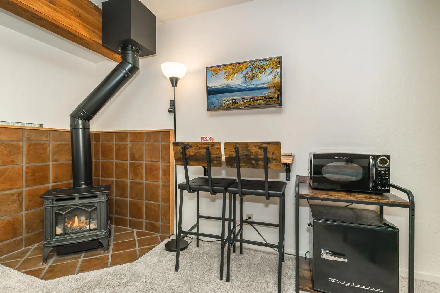 Gas stove, microwave, mini-fridge, and table