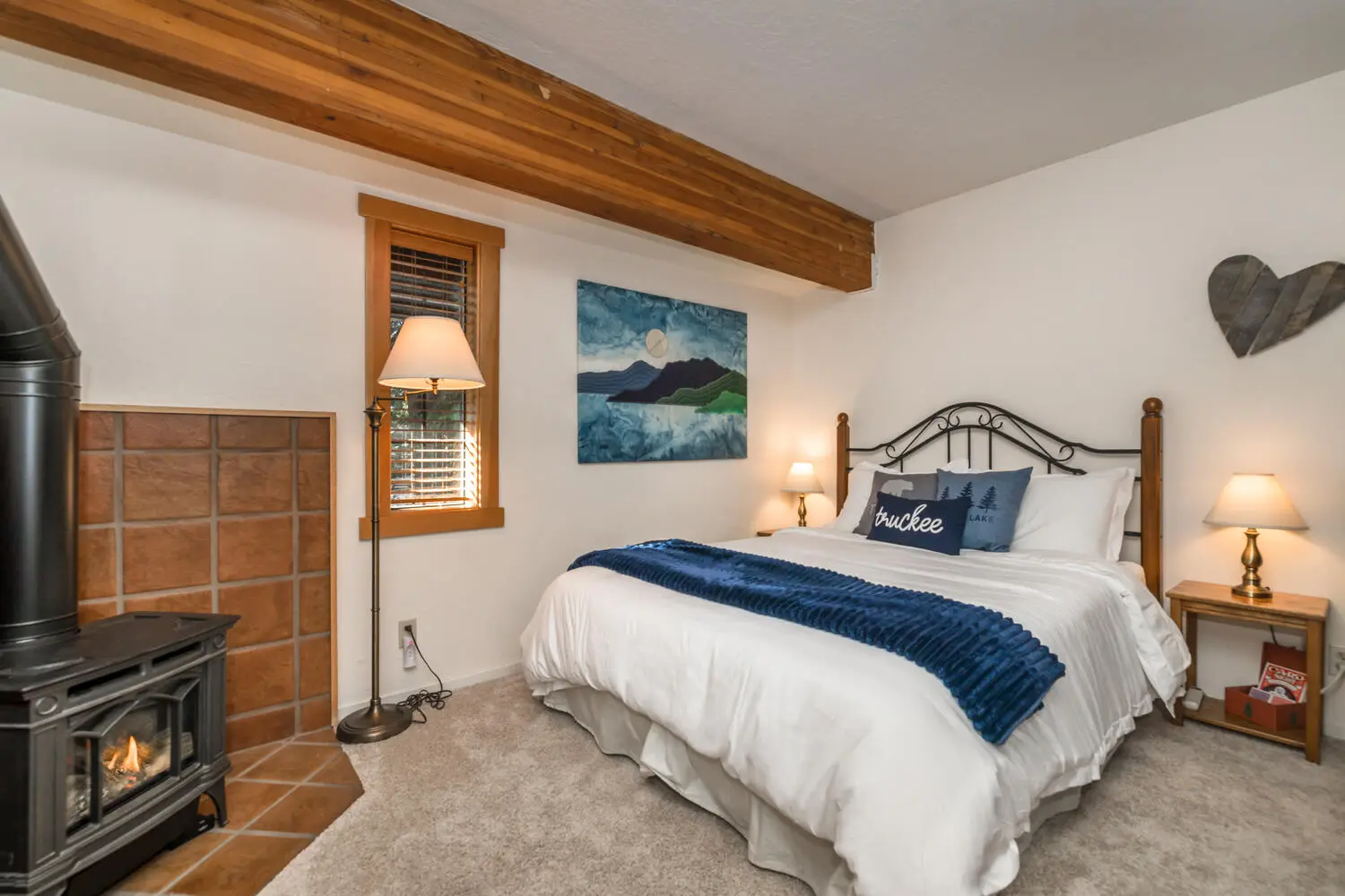 Queen bed and gas stove in the Superior Suite